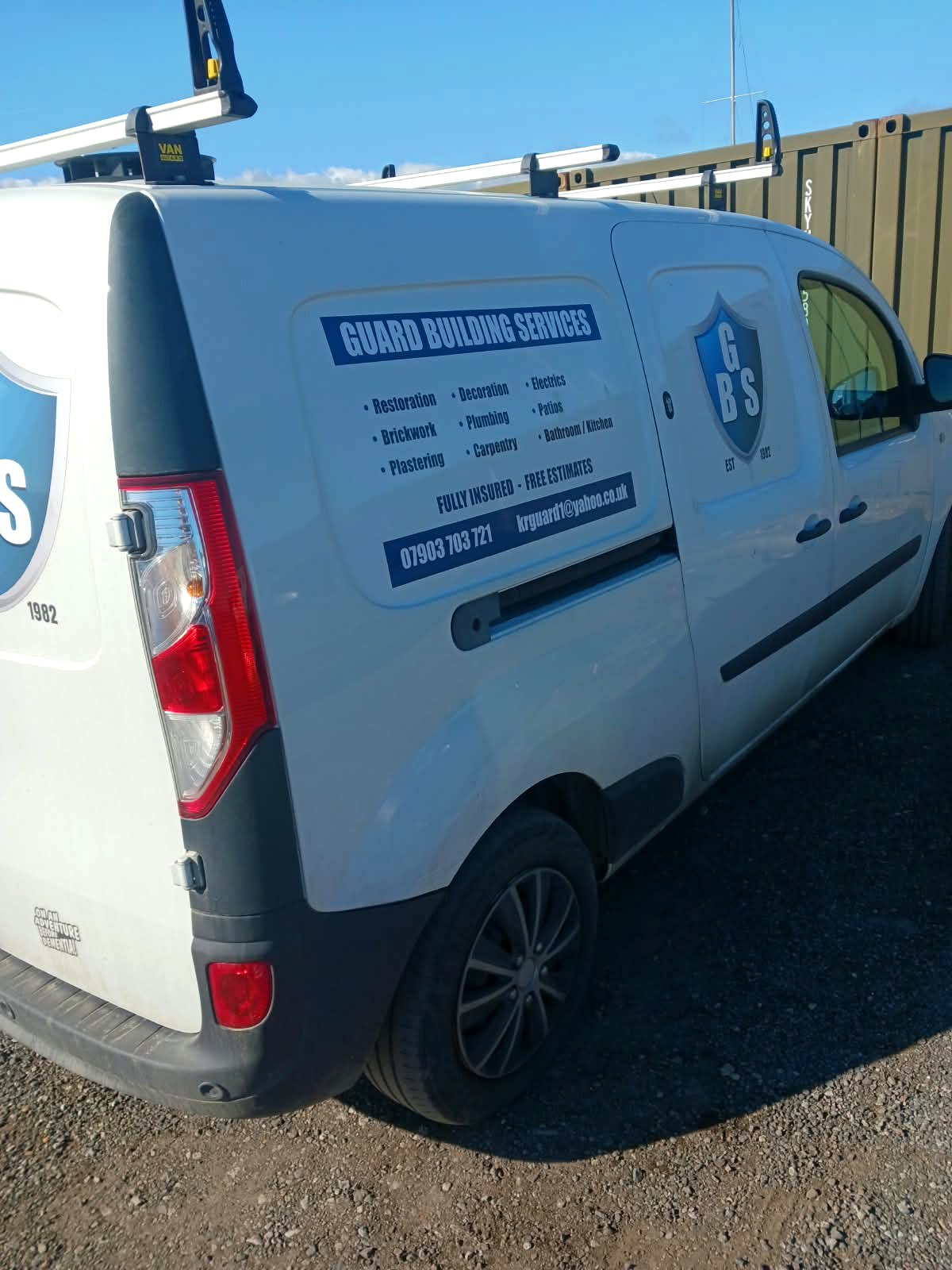 White Guard Building Services van with the building work list on the side